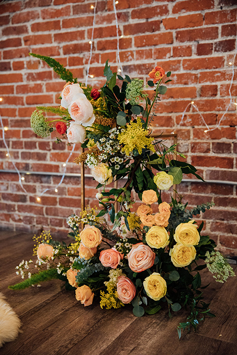  yellow and orange colored flowers on the ceremony arch 