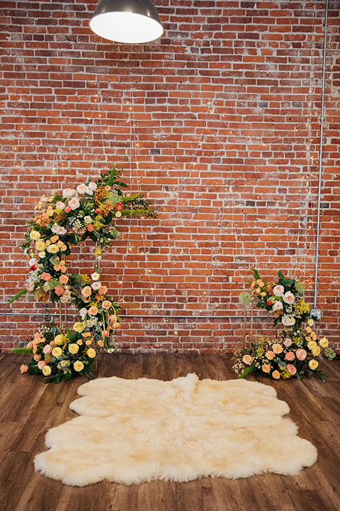  yellow and orange colored flowers on the ceremony arch 