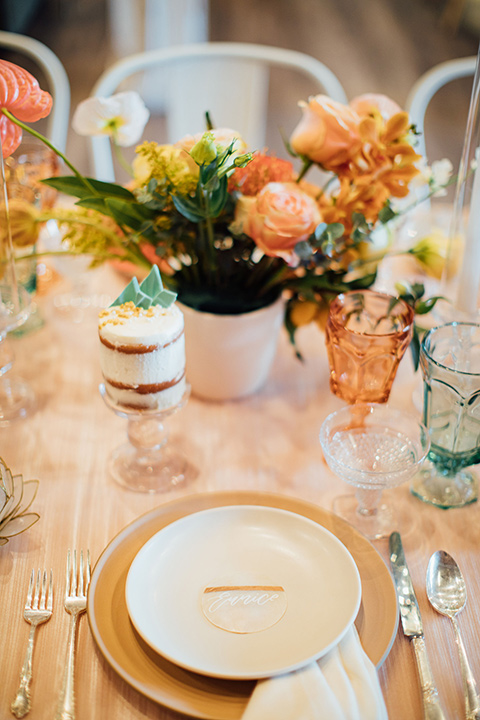  peach and gold table scape décor with blue glass menus 