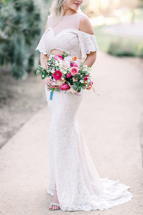  the bride in a white bohemian gown with a high neckline and cold shoulder detail 