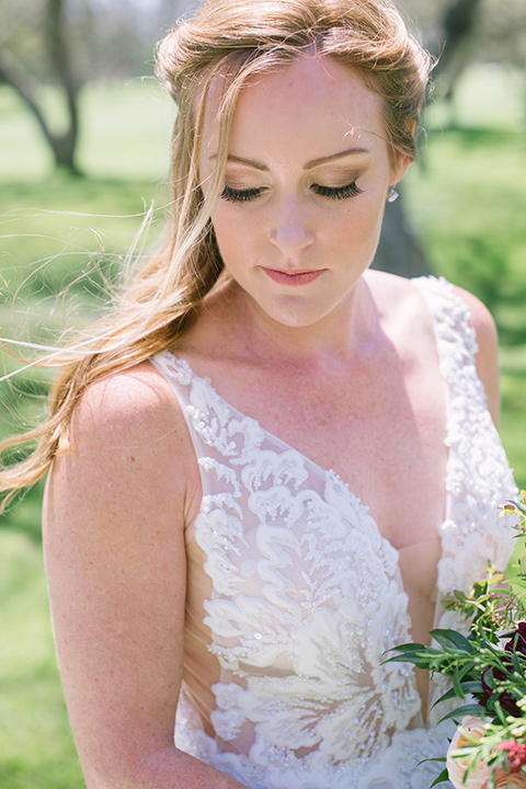  bride in a flowing a line gown with a lace bodice in a low cut neckline 