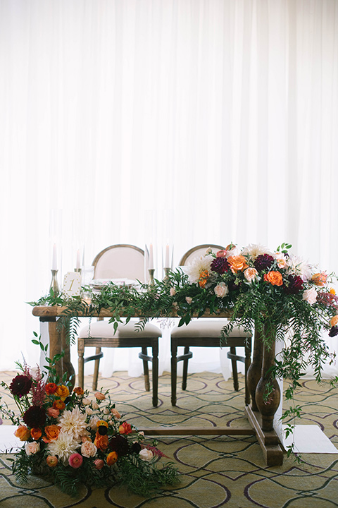  sweetheart table with a rustic décor and florals