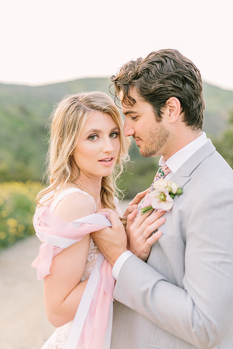  bride in a French inspired casual flowing gown and the groom in a light grey peak lapel suit