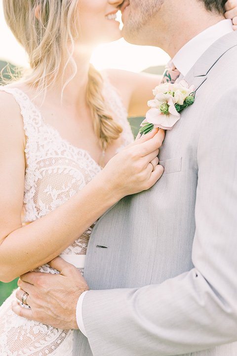  bride in a French inspired casual flowing gown and the groom in a light grey peak lapel suit