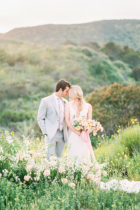  bride in a French inspired casual flowing gown and the groom in a light grey peak lapel suit