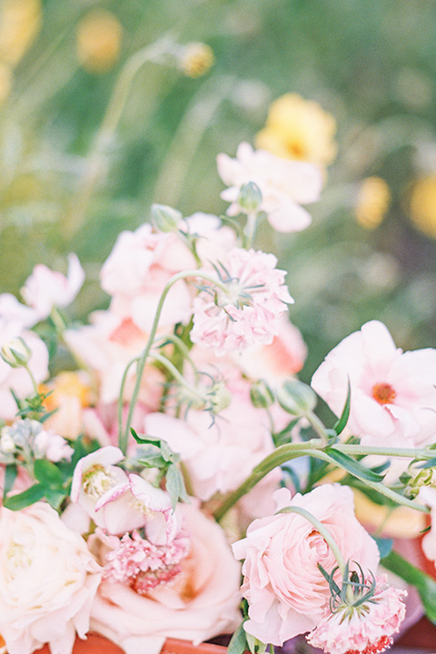 bride in a French inspired casual flowing gown and the groom in a light grey peak lapel suit