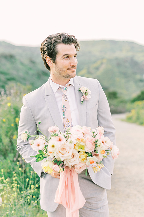  bride in a French inspired casual flowing gown and the groom in a light grey peak lapel suit