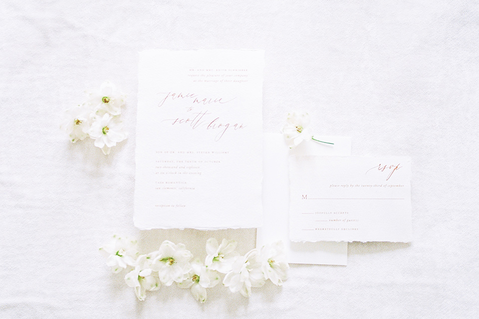  white invitations with calligraphy