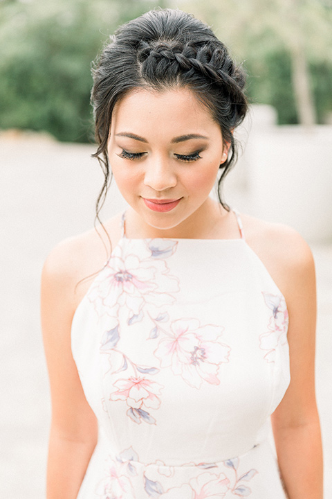 bride in a floral gown with a high neckline and a low bun hairstyle