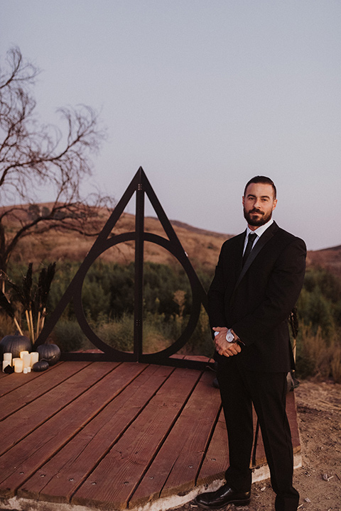  groom in a black velvet tuxedo and black bow tie 