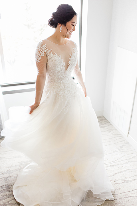  bride in a tulle ballgown with a plunging neckline and a loose bun 