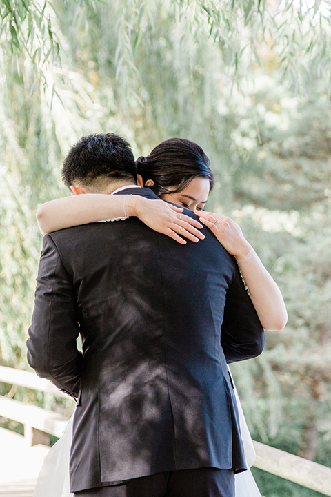  bride and groom hugging after first look