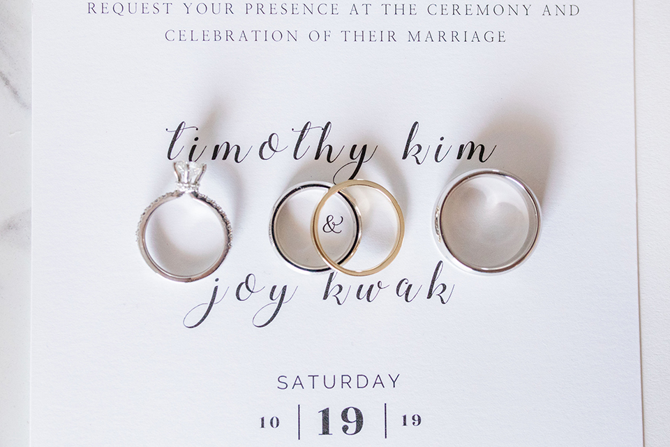  white invitations and rings