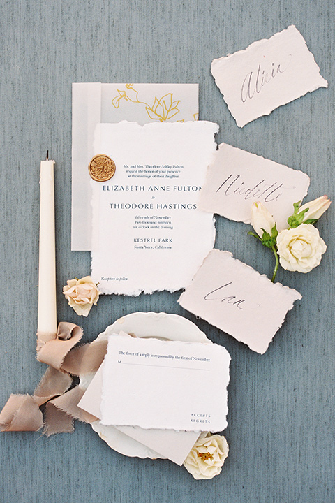  white invitations with blush flowers and calligraphy