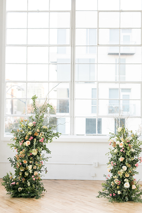 ceremony floral arch in front of windows