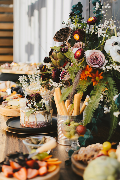 bohemian wooden table with appetizers and deserts on it