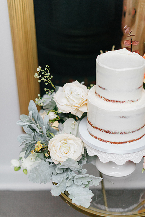  white cake with white flowers as decor