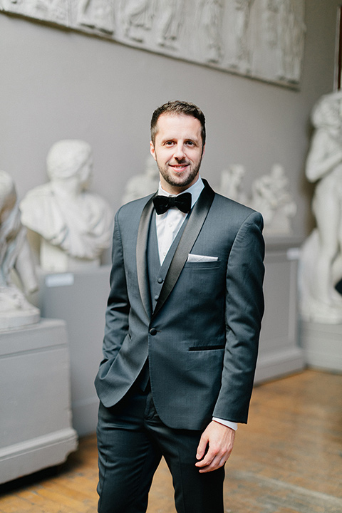  the groom in a navy shawl lapel tuxedo with a black satin lapel