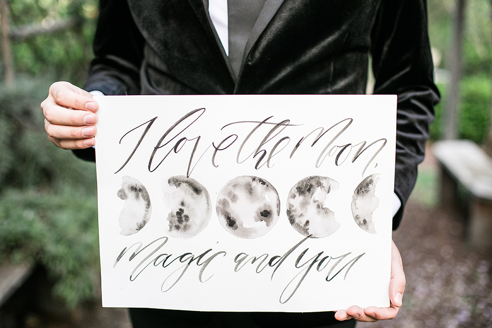  groom holding a welcome to the wedding sign 