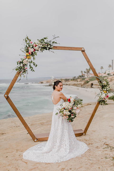 bride in a white lace gown with a soft long skirt and a low cut back