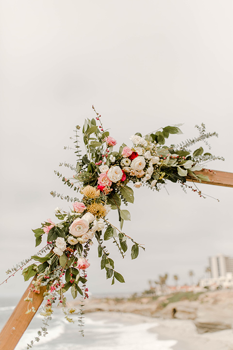 the wooden arch with a pink and green floral design