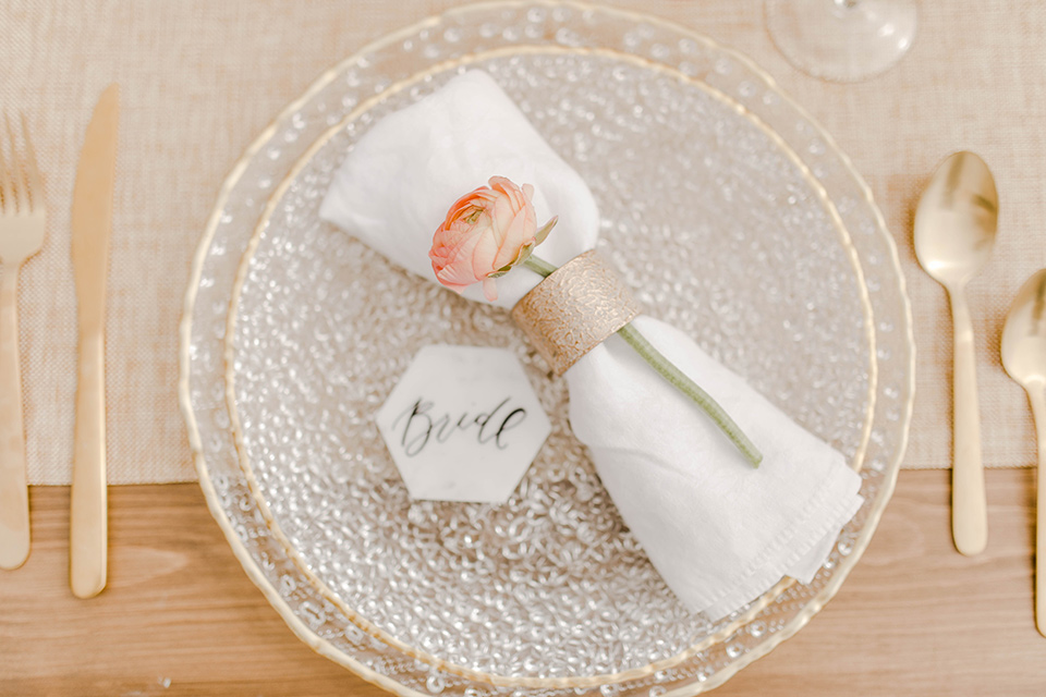  silver and white plates and linens with gold flatware