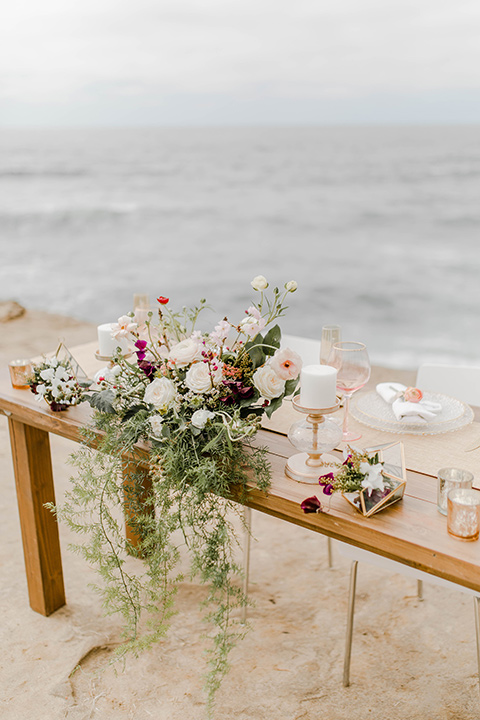  wooden tables with bountiful florals and white plates