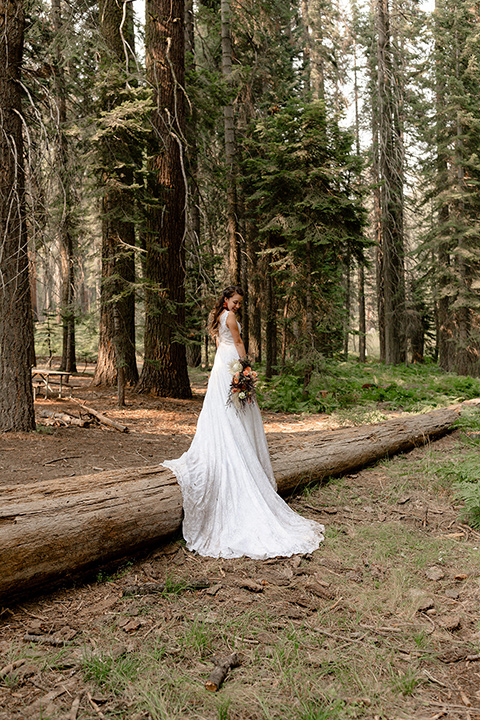  bride in a lace white gown with lace straps and a formfitting bodice 