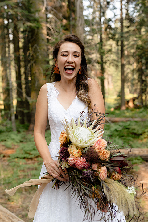  bride in a lace white gown with lace straps and a formfitting bodice 