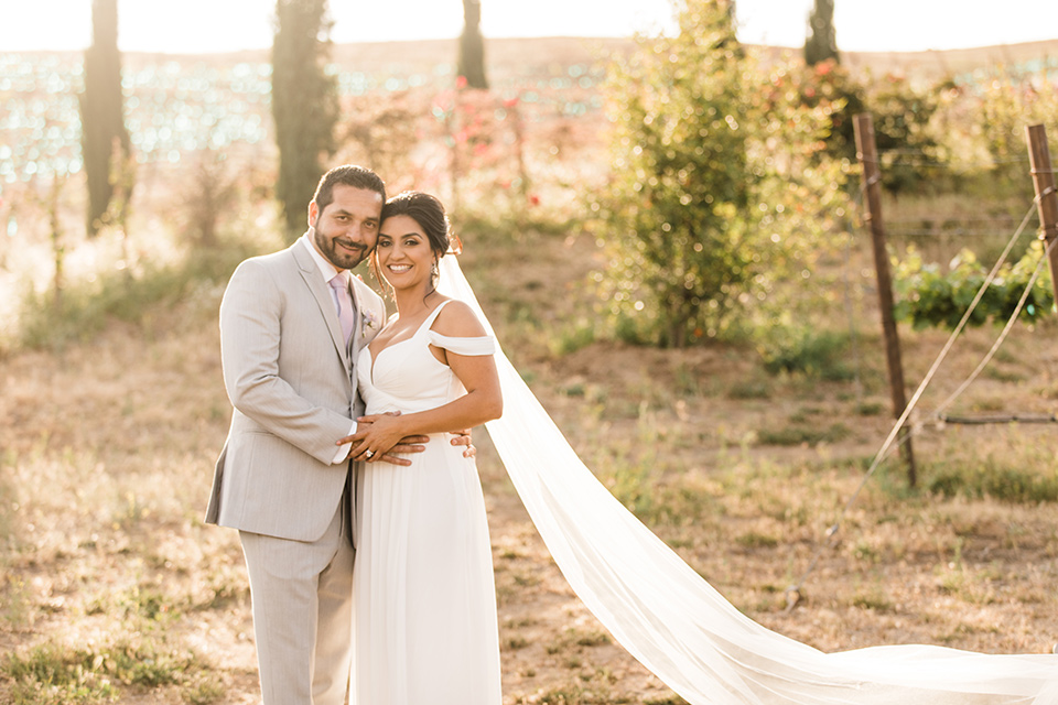  bride in a white flowing gown with off the shoulder detailing 