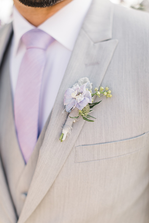  groom in a light grey suit with a lavender long tie