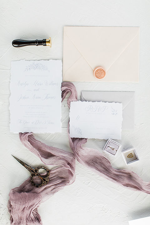  white and lilac colored invitations with gold lettering