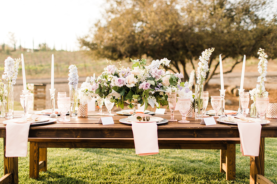  reception tables with tall white candles and linens