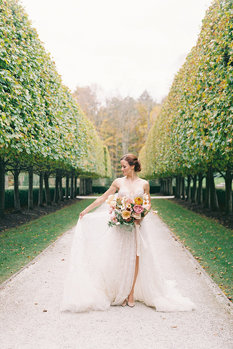  bride in a tulle ivory ballgown with a natural waist and jeweled detailing and a modern whimsical updo 