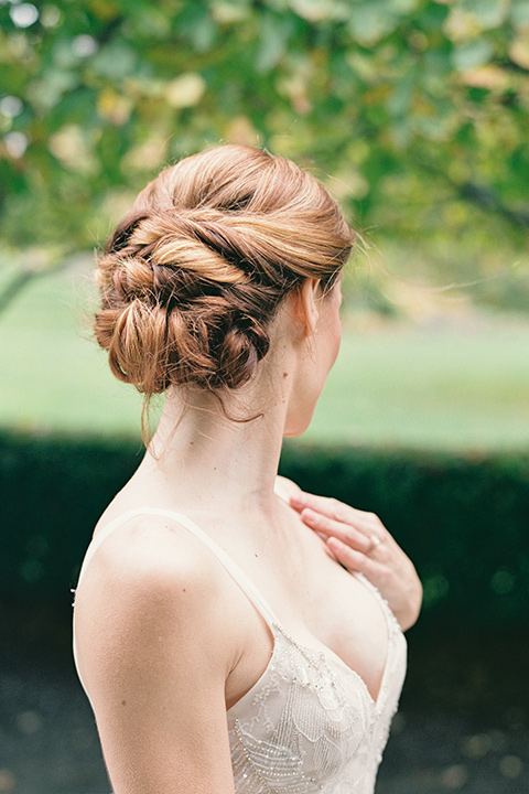  bride in a tulle ivory ballgown with a natural waist and jeweled detailing and a modern whimsical updo 