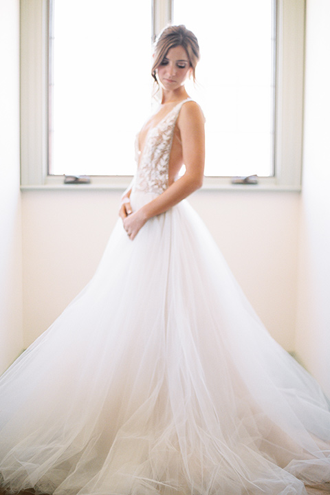  bride in a long flowing gown with long sleeves and a plunging neckline