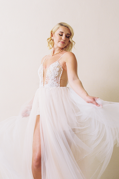  bride in a modern bohemian gown with a sheer skirt and crystal embellishments 