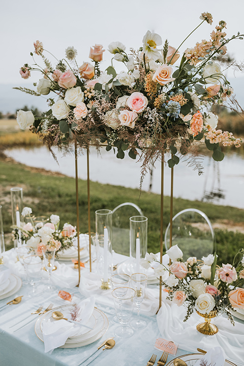  bride in a flowing lace gown and the groom in a rose pink suit