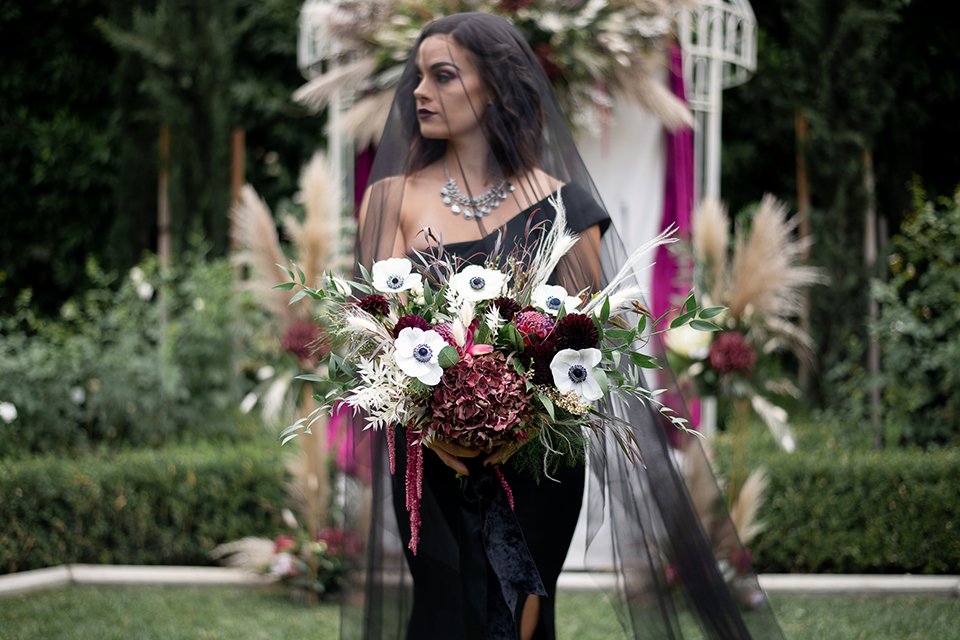  bride in a black gown with a black veil 