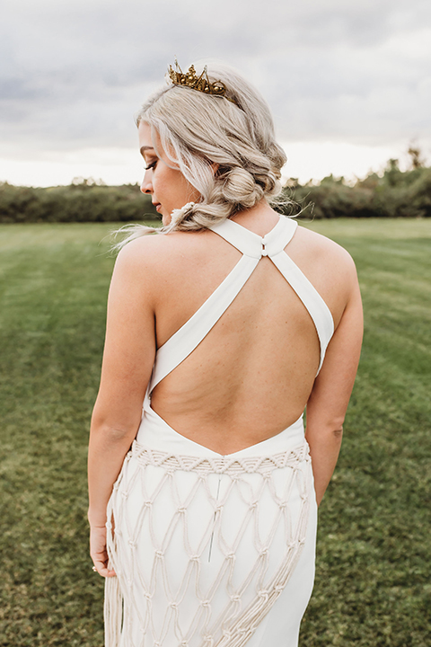  bride in a boho gown with her hair in a long french braid 