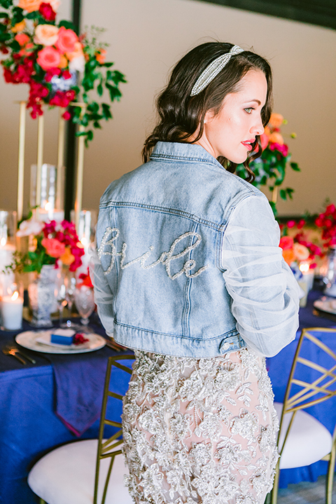  the bride in a lace gown and jean jacket 