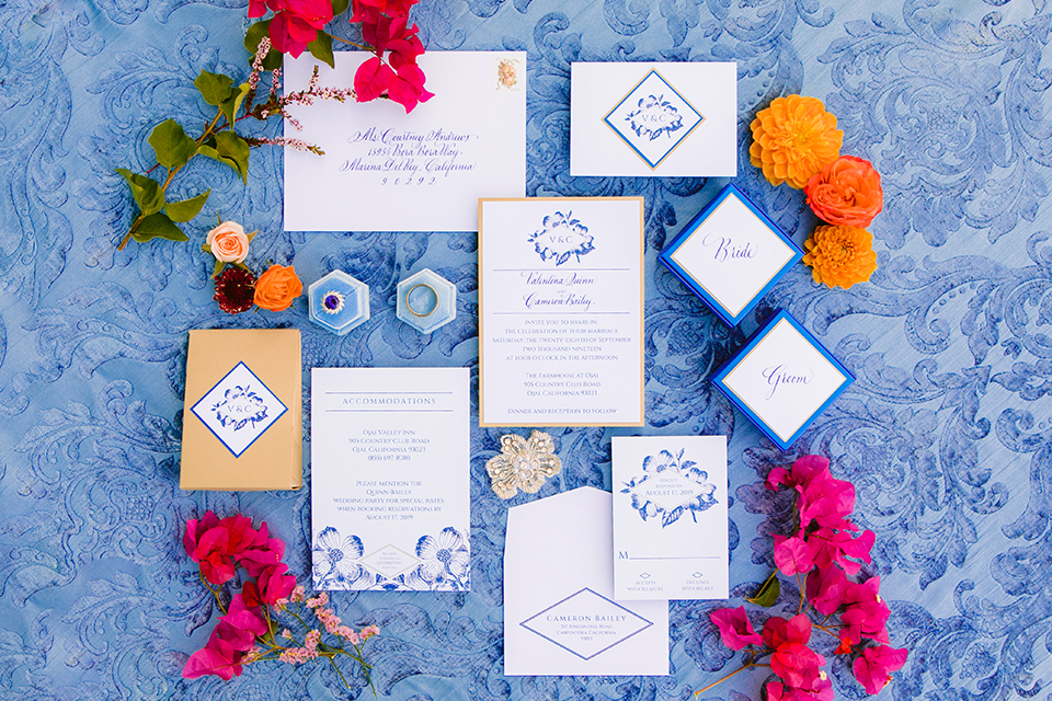  the bride in a lace gown and jean jacket and the groom in a light blue suit with a white floral long tie 