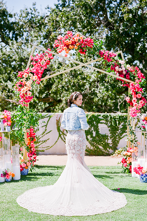  the bride in a lace gown and jean jacket 
