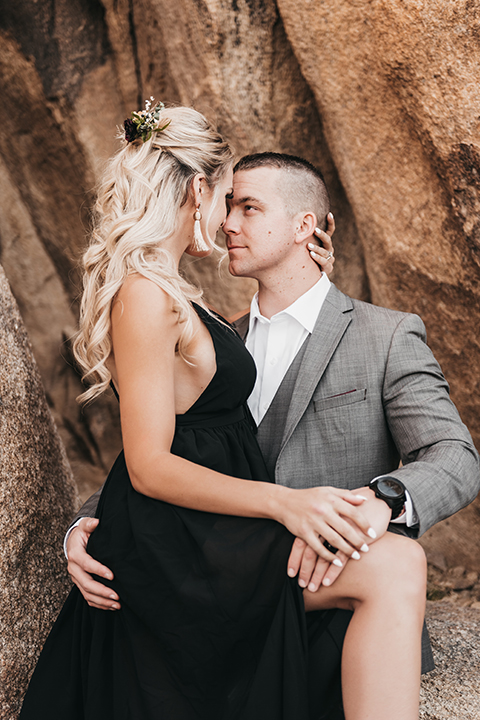  bride in a black gown and the groom in a café brown suit