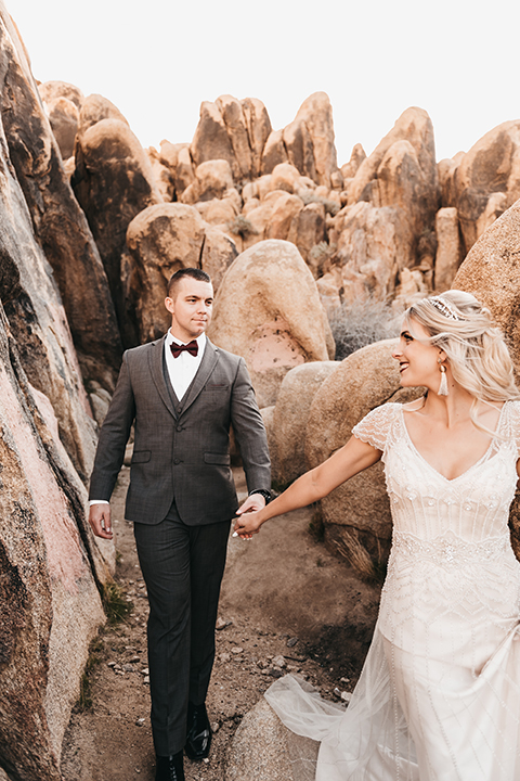  bride in a black gown and the groom in a café brown suit