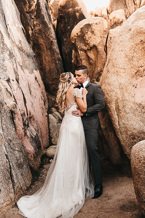  bride in a black gown and the groom in a café brown suit 