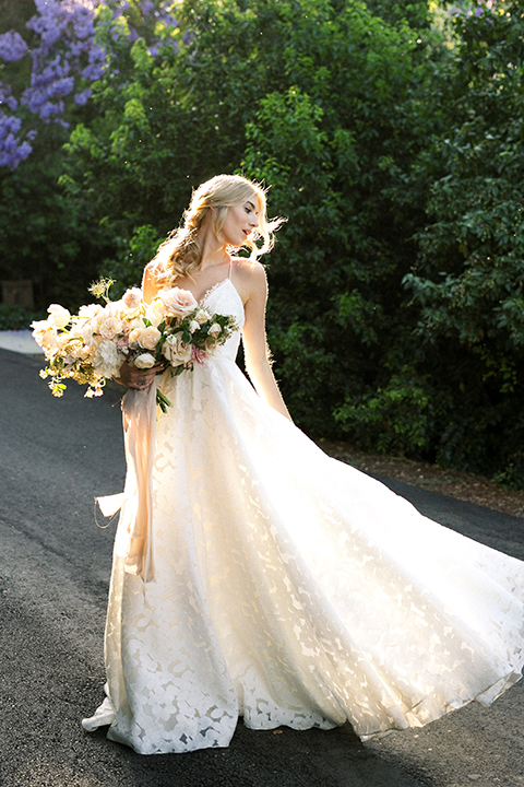  bride in a white flowing gown with a full skirt  