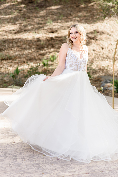  the bride in a white full ball gown with straps 