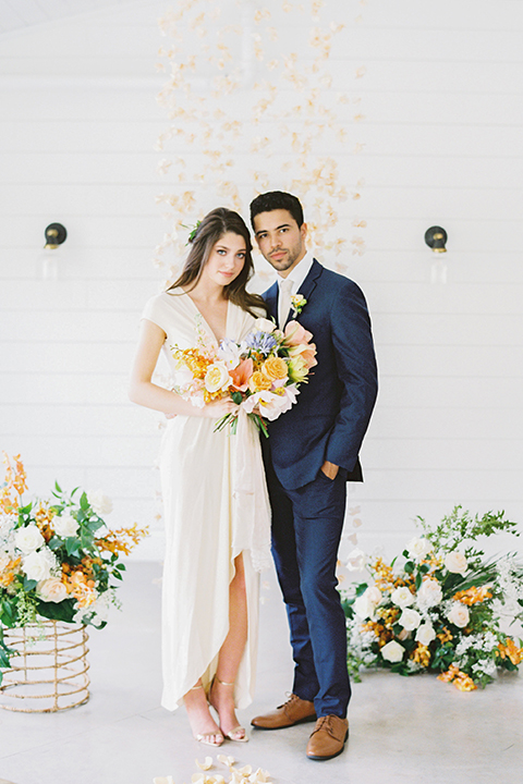  ruffled shoot in texas – bride in a romantic casual wrap dress and the groom in a blue suit with a white long tie