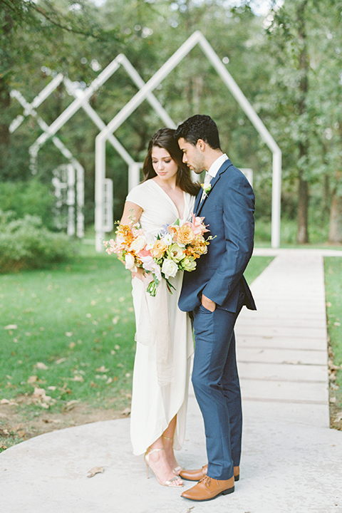  ruffled shoot in texas – bride in a romantic casual wrap dress and the groom in a blue suit with a white long tie